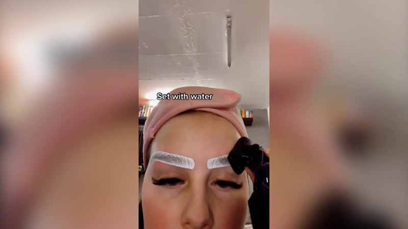Woman uses temporary tattoo eyebrows