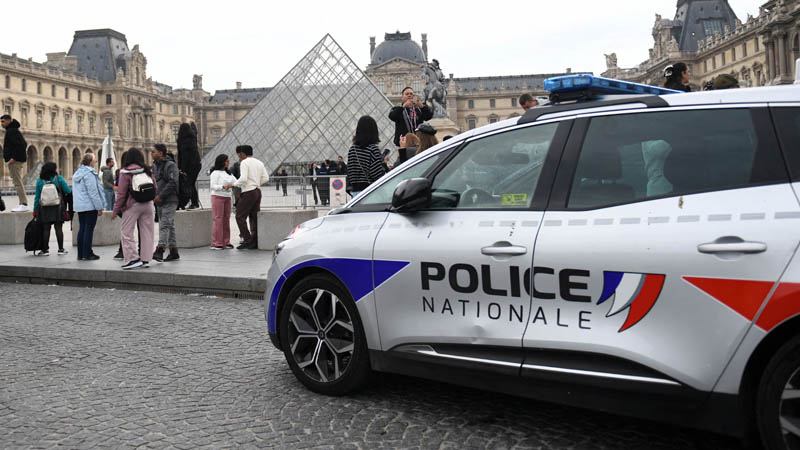 Police work near the Pyramid at the Louvre