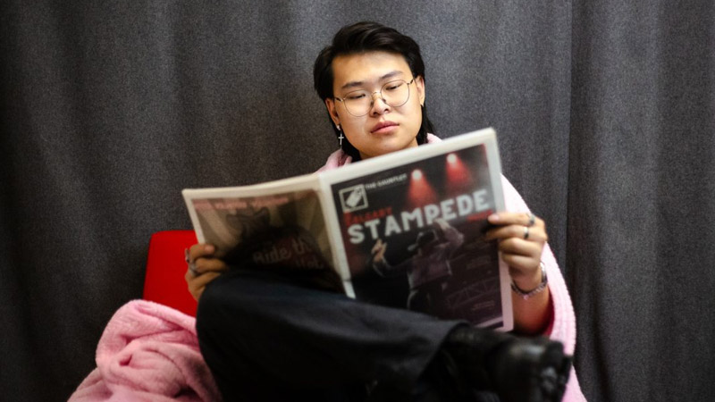 student reads newspaper